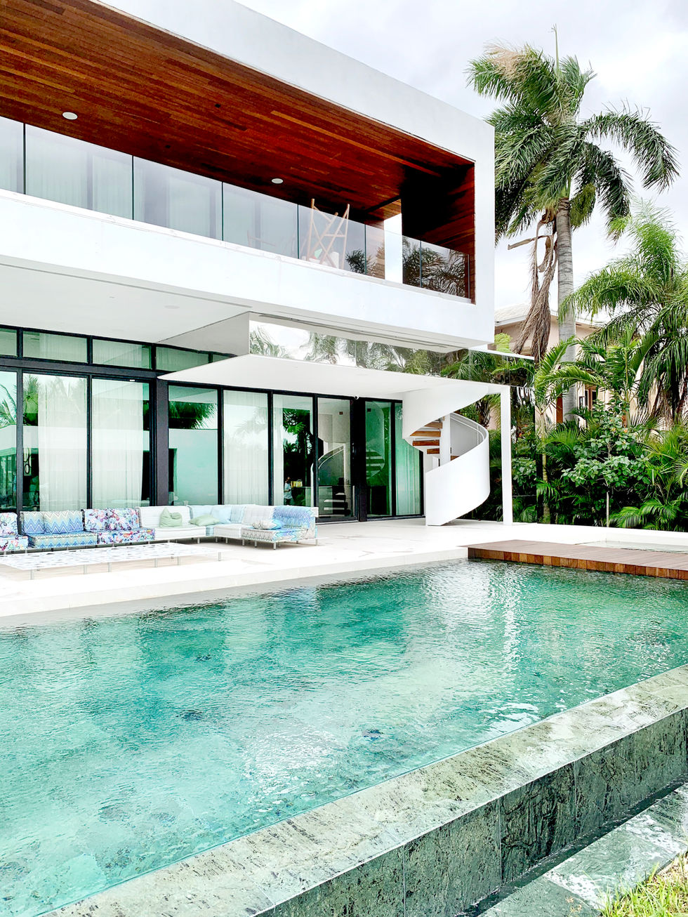 Green marble infinity pool overlooking tropical garden, Palm Island residence, Miami Beach