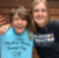 Two-musical-theater-camp-students-hug-during-a-dress-rehearsal-in-lakewood-ranch-florida