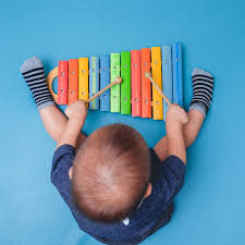 Group of children exploring instruments and props during a music class western suburbs Melbourne.