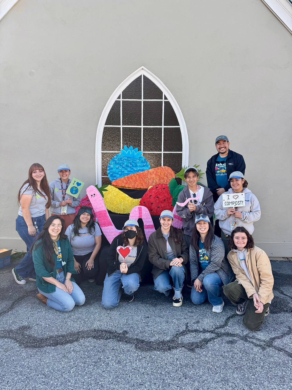 Food ED team members posing with fruit and worm pinatas