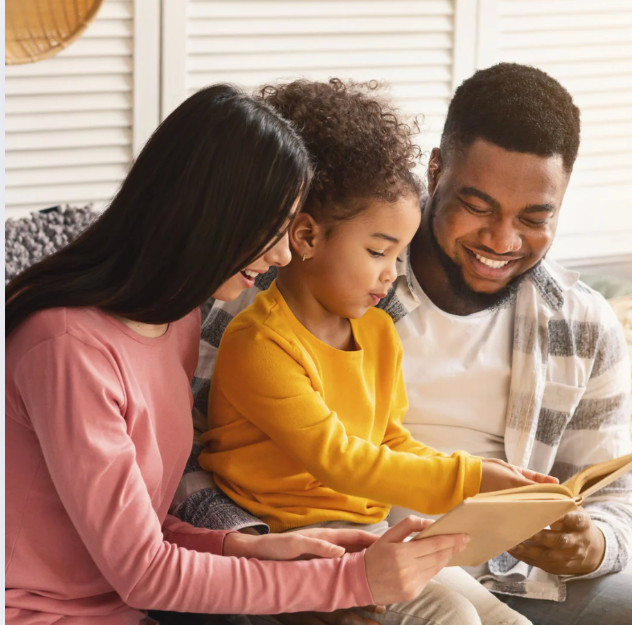 Child reading with parents