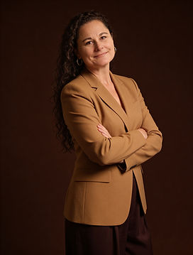 Shalene in brown business suit smiling at camera