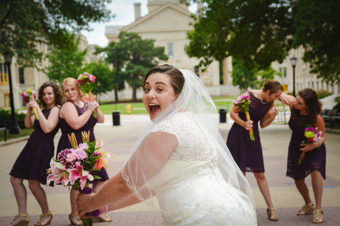 Happy bride getting ready to toss her bouquet