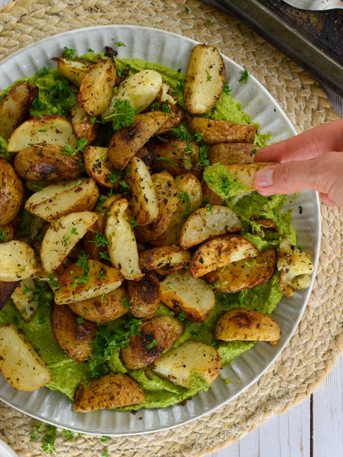 Herby roasted potatoes on zesty spinach hummus base