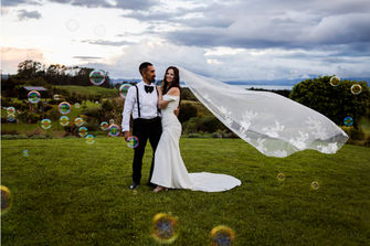 beautiful portrait of couple on their wedding day with bubbles at Tironui Wedding venue Bay of Plenty