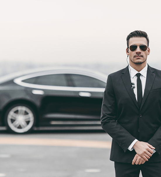 Bodyguard next to car