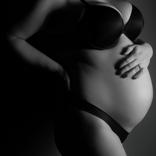 Black and white close up maternity portrait highlighting baby bump in Bedford TX studio