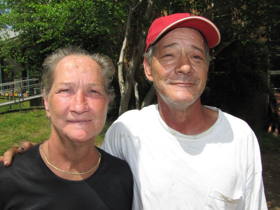 Two guests attend an event to receive a free meal from the soup kitchen.