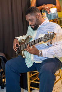 A man playing the guitar on stage at the Power of the Plate Gala
