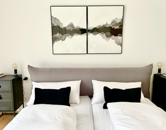 master bedroom bed zoom view with black cushions HERO.jpg