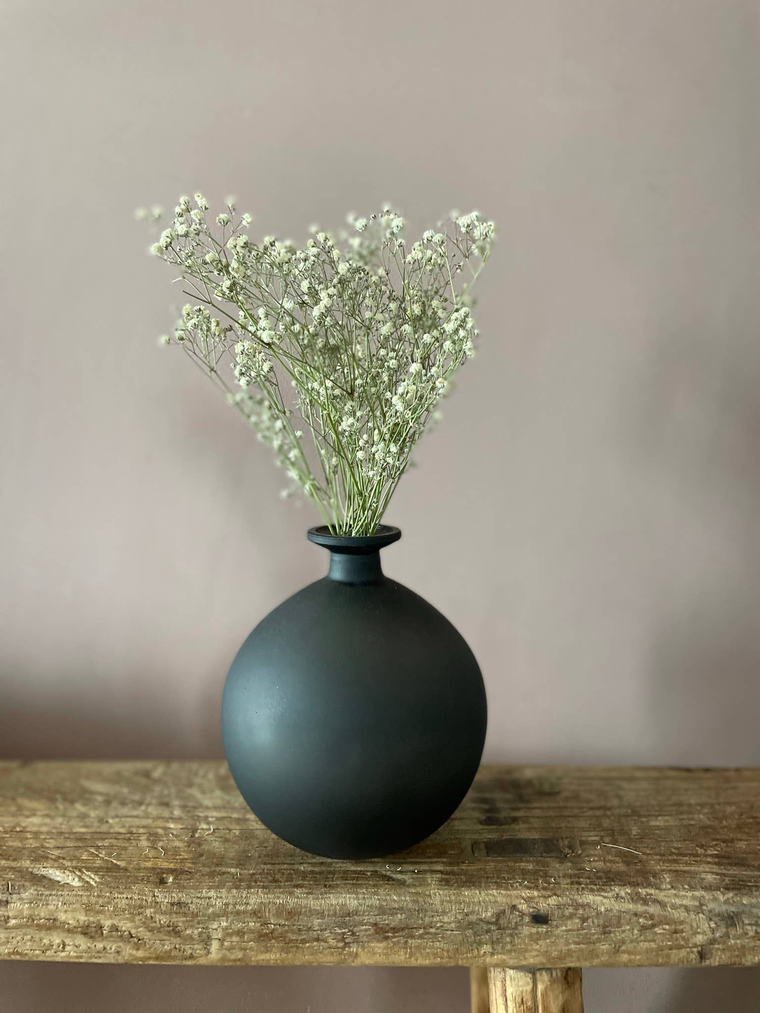 Matt black round glass bottle