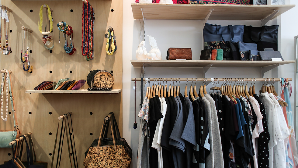 An organized closet space showing jewelry, bages, shirts, and more