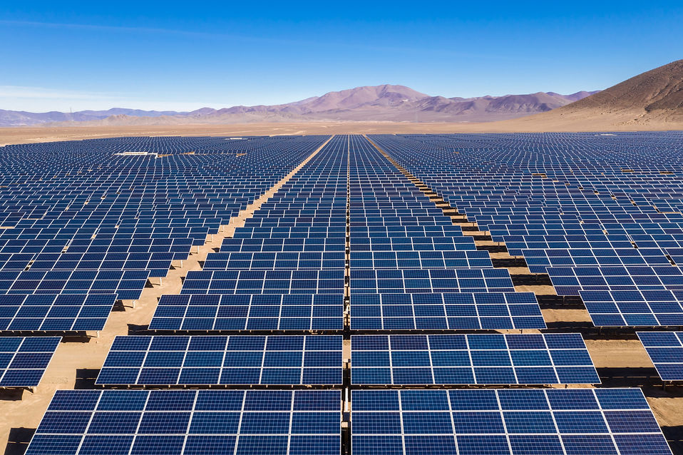 Aerial view of hundreds solar energy modules or panels rows along the dry lands at Atacama