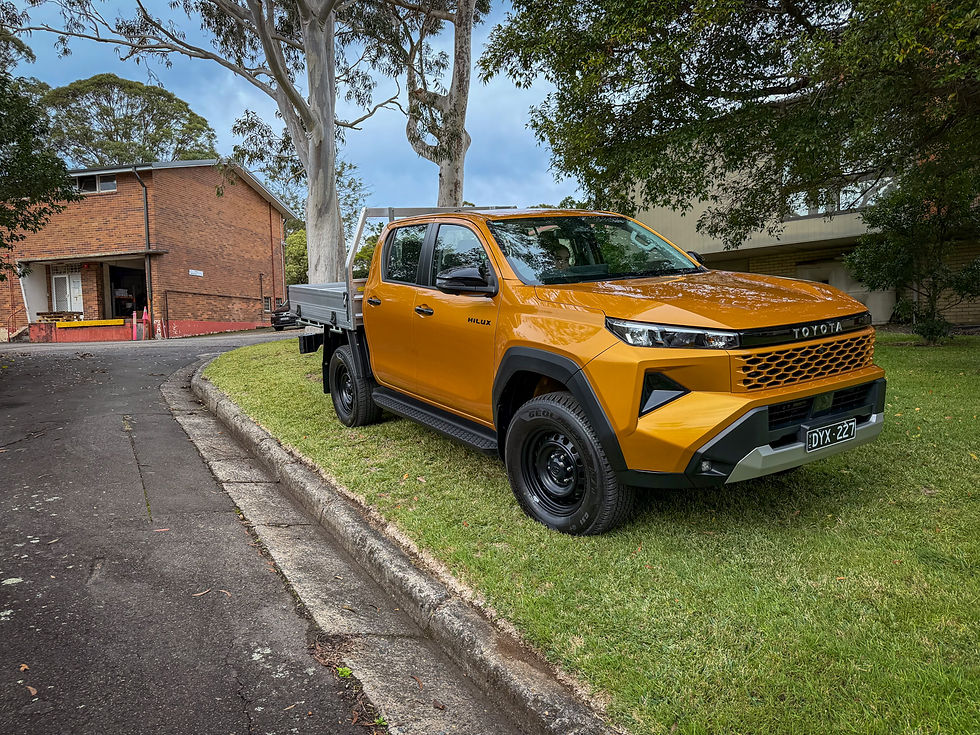 An orange utility parked on a grass verge