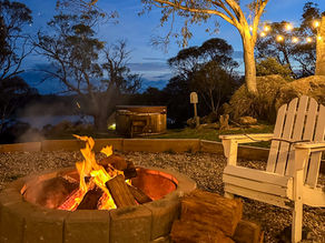 White seats by a campfire overlooking a lake