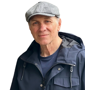 Author Jay Raven smiling naturally at the camera wearing a cloth cap and blue coat