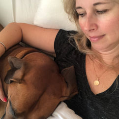 Author Saz Wilson hugging Otis in bed