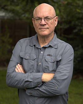 Author Jeff Kerr profile photo showing a man in a grey shirt with his arms folded