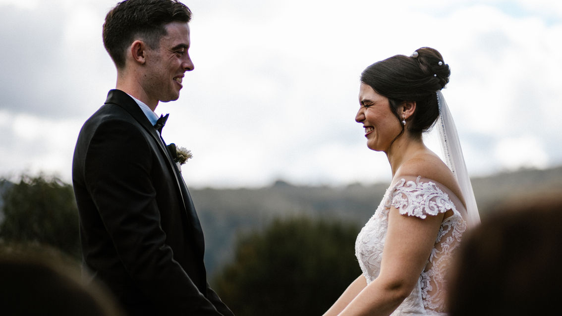 Couple exchanging vows with misty Blue Mountains backdrop