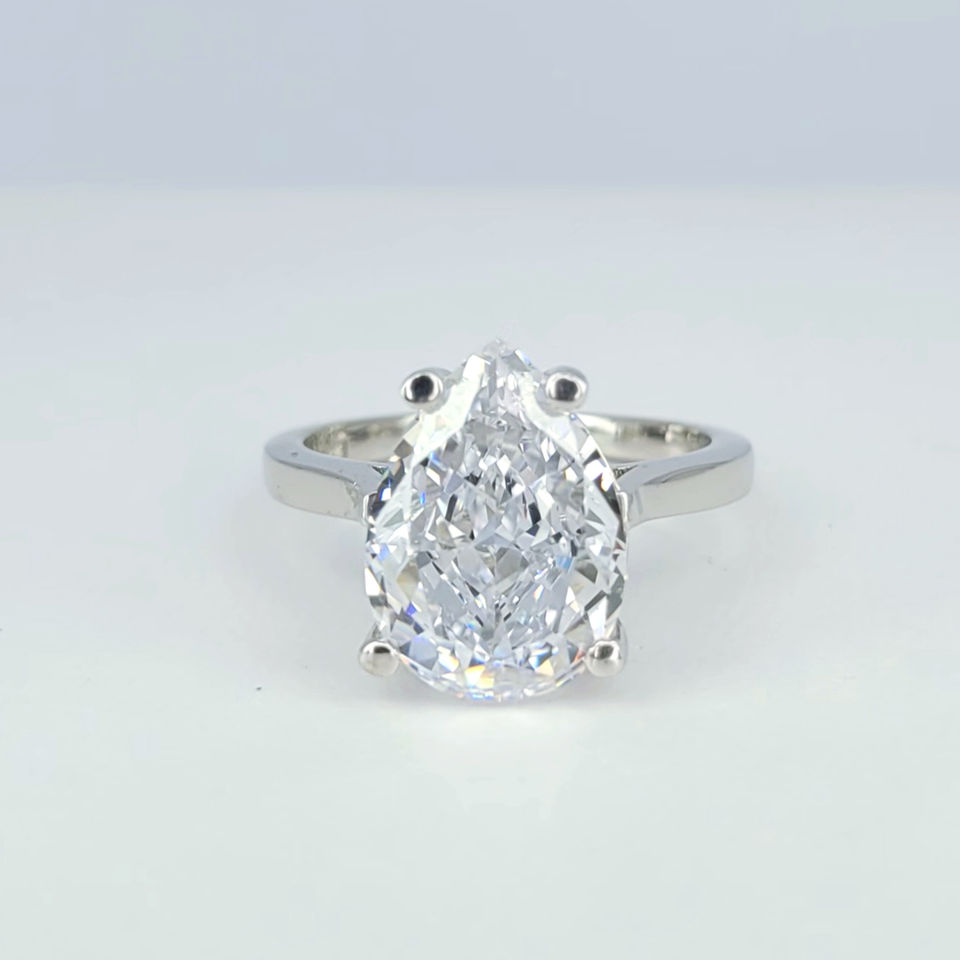 Silver ring with a center pear cut white Topaz