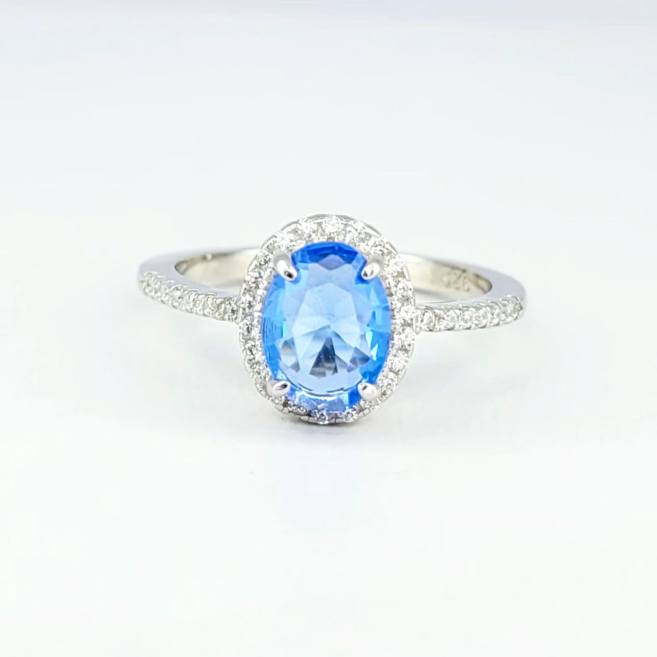 Ring with big oval cut Tanzanite surrounded with pave white Topaz