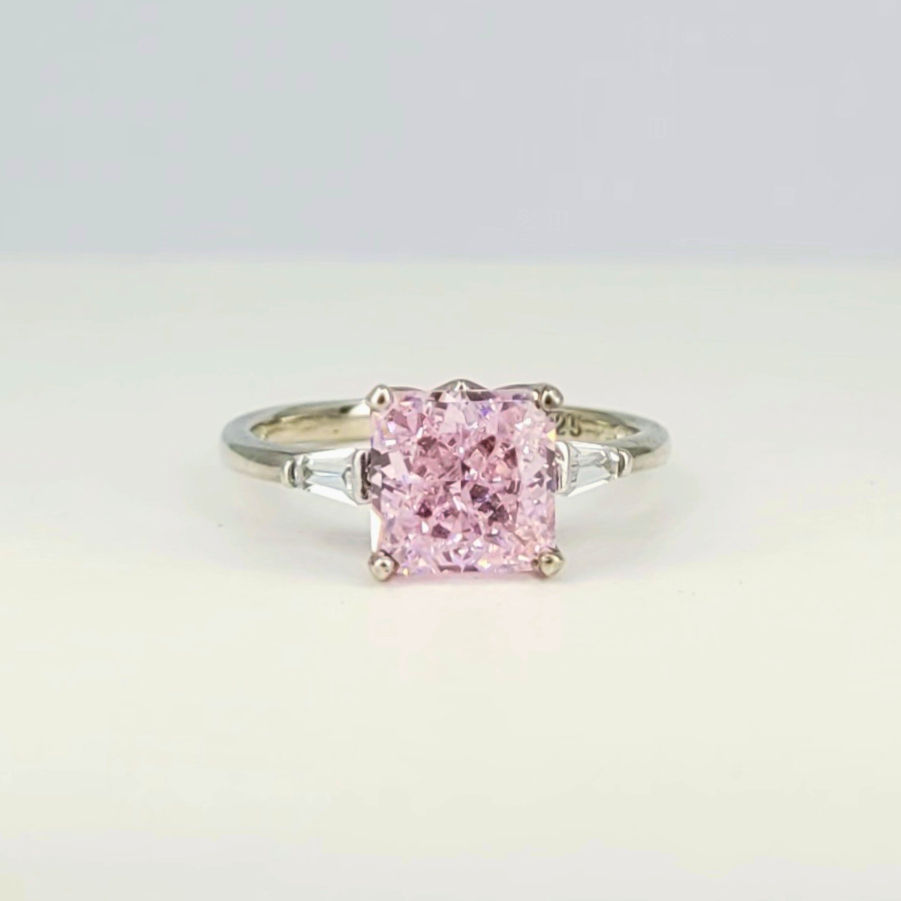 Silver ring with centered pink Topaz and white Topaz on the side
