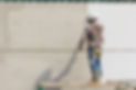 young-painter-with-blue-cap-gloves-painting-wall-with-paint-roller.jpg