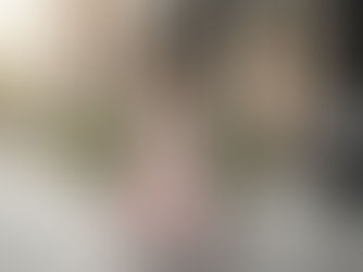 Elegant woman wearing a blush pink maxi dress walking in Toronto near a boutique.