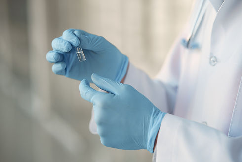 person-white-uniform-holding-ampoule-her-hands.jpg