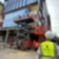 Tradespeople applying render to apartment block exterior