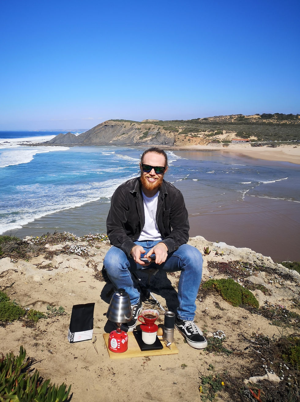 man making filter coffee outdoors v60 on a clifftop beach