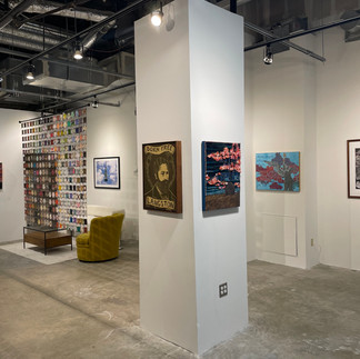 Gallery wall and column displaying artwork from the Ad Astra Per Aspera exhibit.