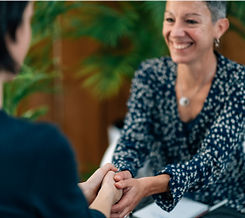 people smiling and shaking hands