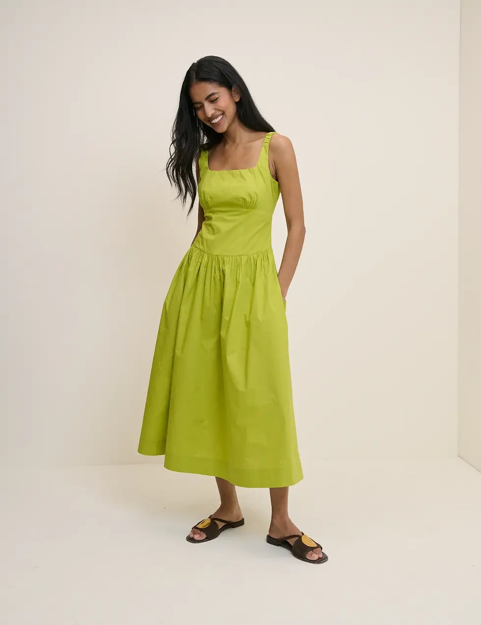 A model wears a chartreuse green summer dress from Nobody's Child