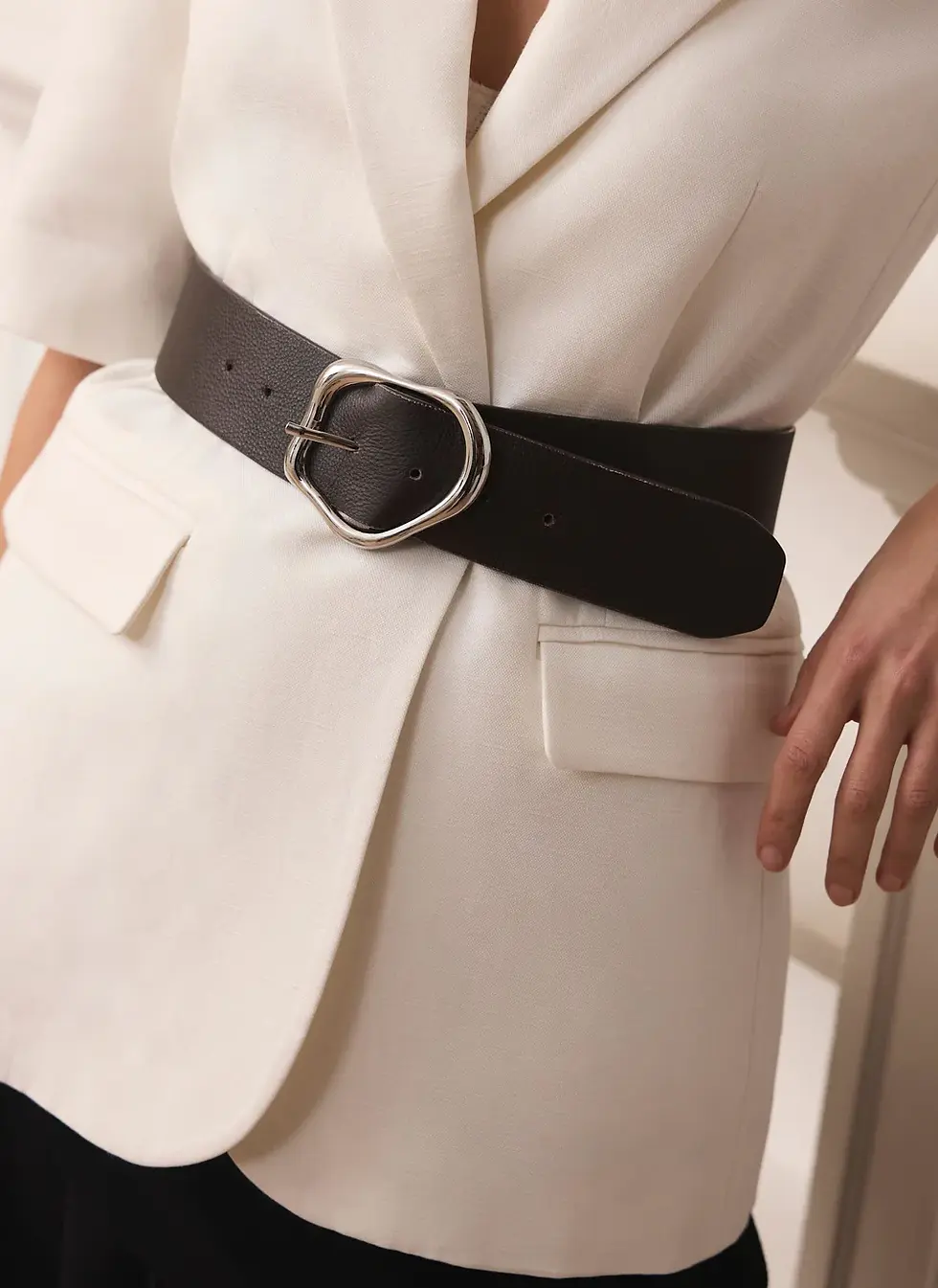Cream blazer with a wide brown belt