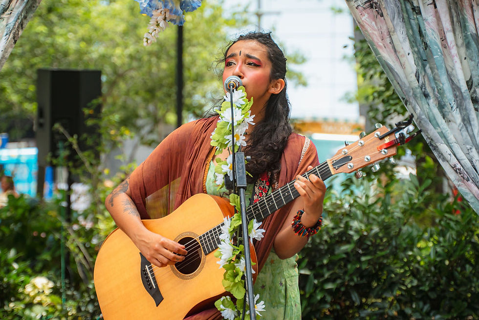 performer playing guitar and singing