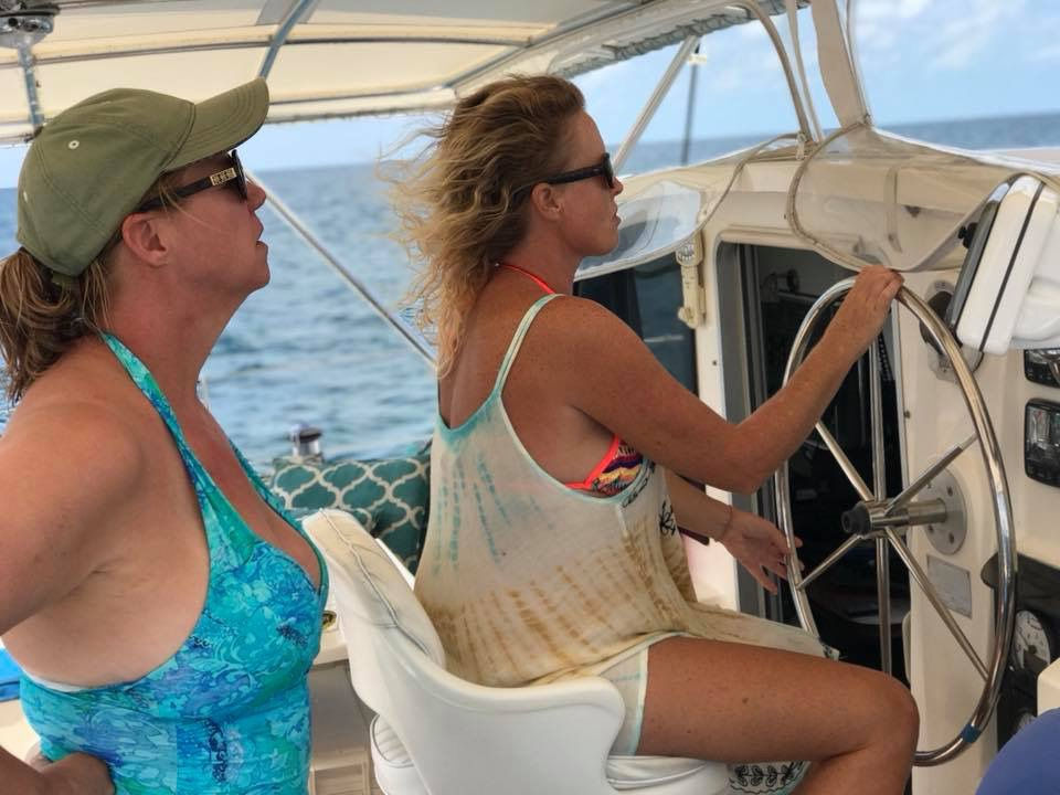 Krista at the helm, Brenda watching
