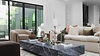 Staged living room with layered pillows, brass lamp and styled coffee table in an Austin home