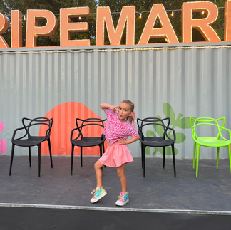 A dance student posing after participating in the British Dance Academy dance performances in Dubai at The Ripe Market.