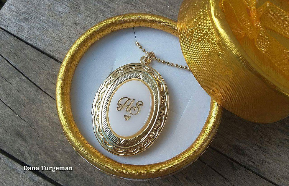 A necklace with an oval pendant that opens in 2 micron gold plating