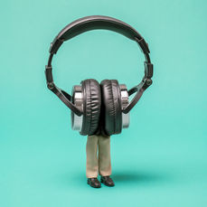 Person immersed in giant headphones, consumed by music