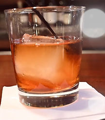 A barrel-aged old fashioned on the bar