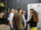 Jeff Hoffman speaking with Campus X members during a startup event, networking in front of a Campus X branded backdrop.