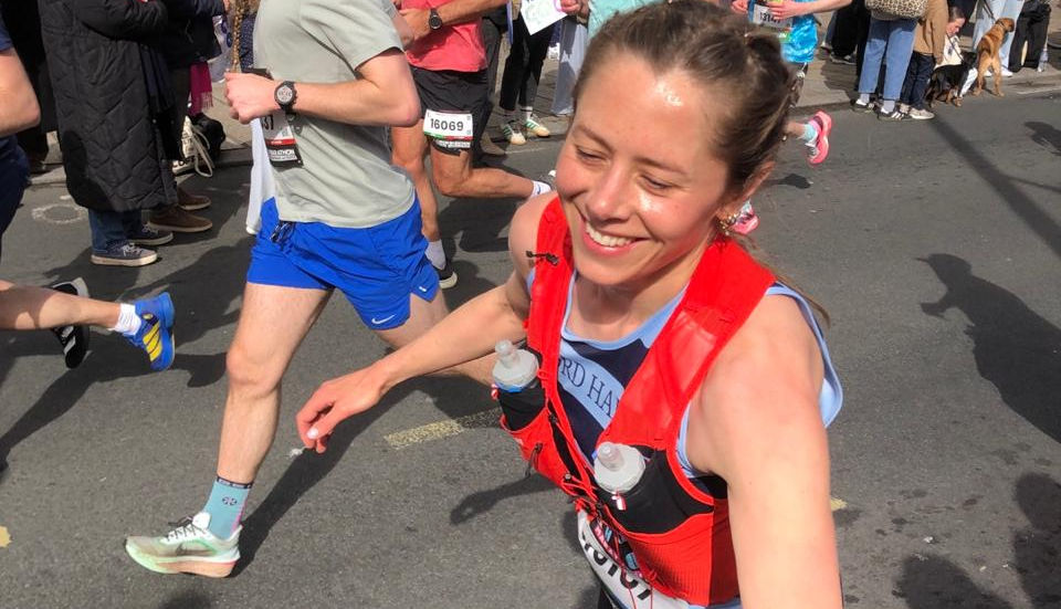 Ali running brighton marathon, giving high five to her children