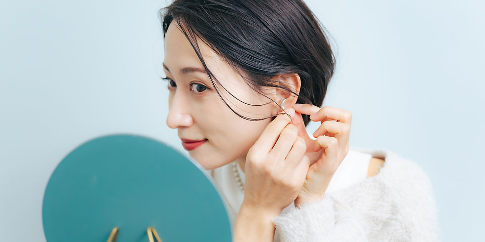 Girl inserting body jewelry into her ear piercing, which is now worn and cannot be returned