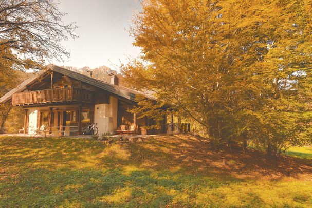Rèfol Lodge facade surrounded by autumn trees in Ledro