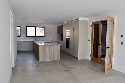 Modern kitchen with island and wooden accents.