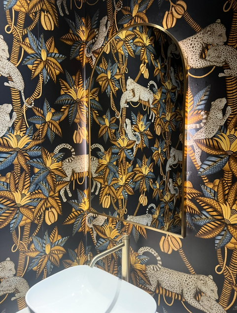 Decorative wallpaper with leopards and tropical foliage.