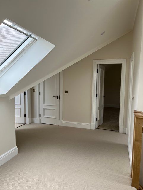 Room with slanted ceiling and skylight window.
