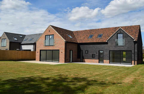 Modern house with brick and dark wood exterior.